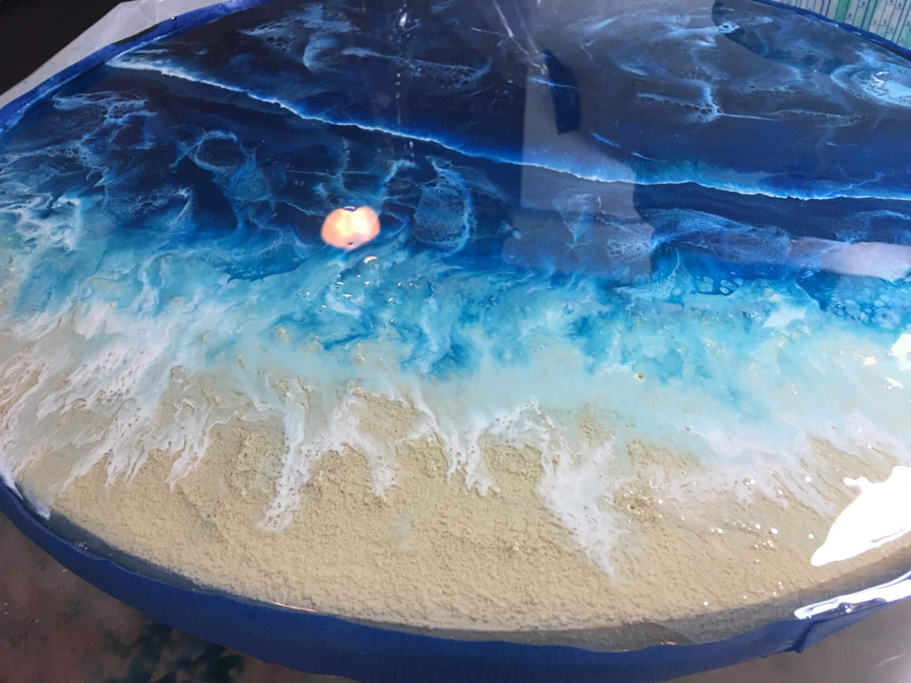 mid process of resin falling over the sand